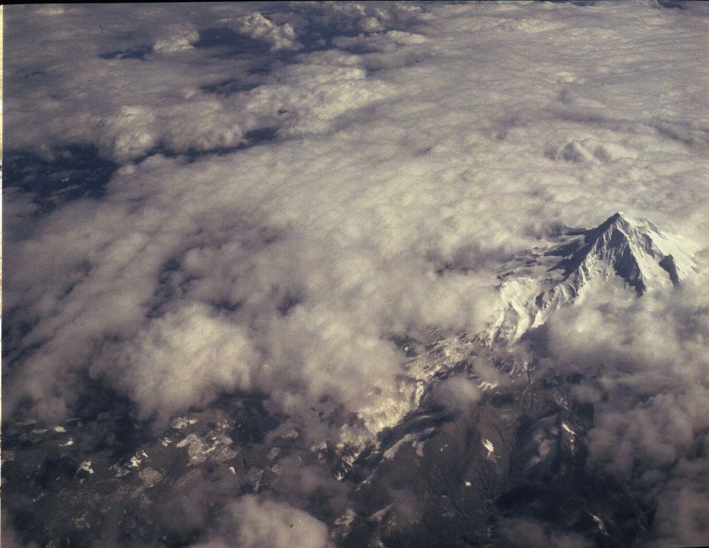Mount Hood rising through clouds, photographed from the flight to Los Angeles on March 9, 2022.