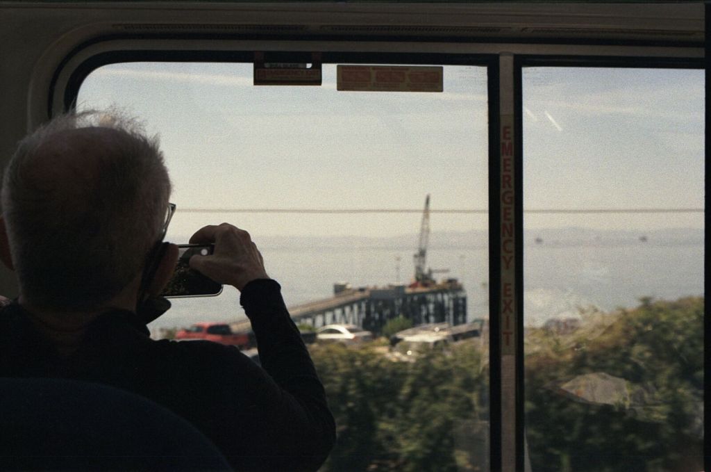 A passenger photographs the coast through a train window during the journey home from California in April 2022.